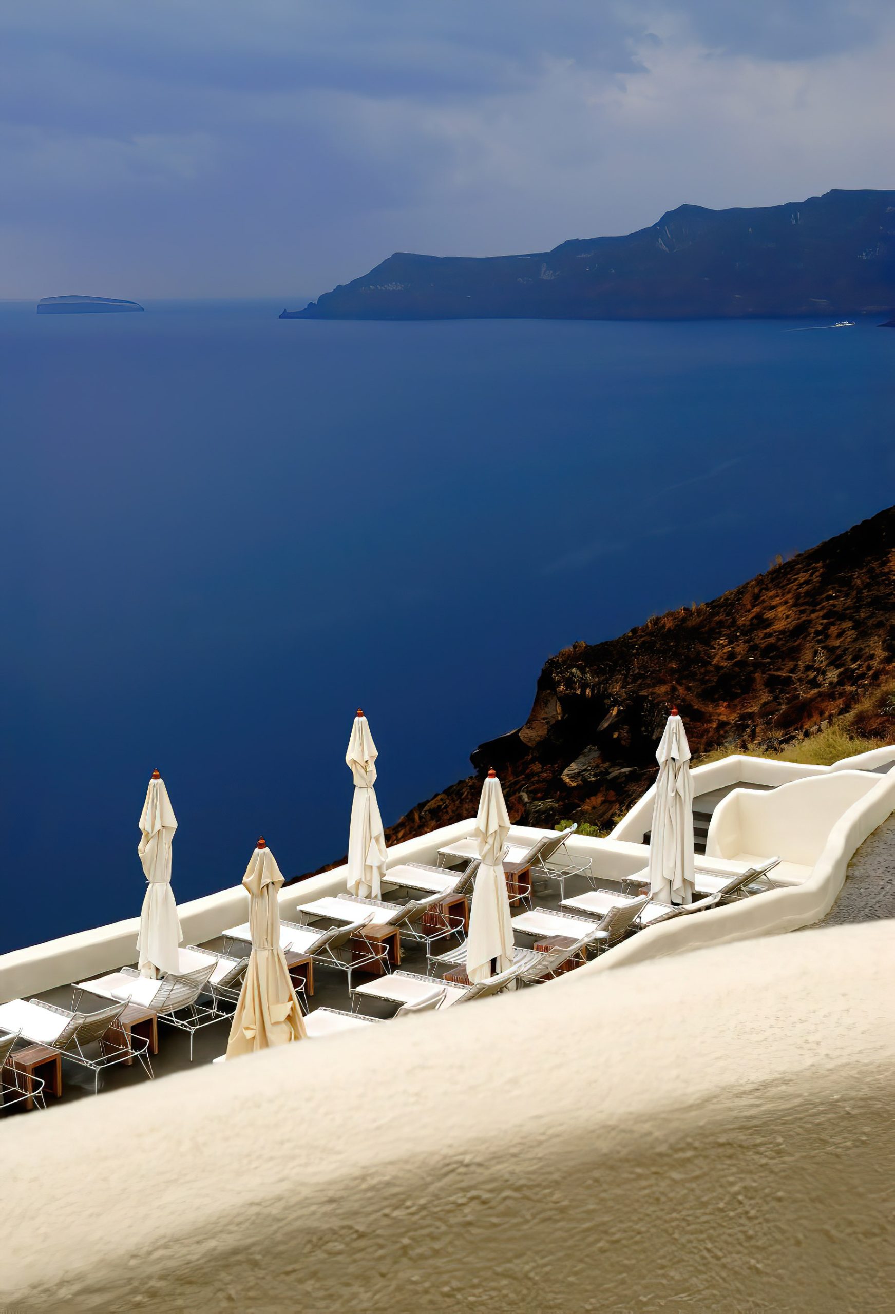 Mystique Hotel Santorini – Oia, Santorini Island, Greece – Ocean View Pool Deck Patio Chairs