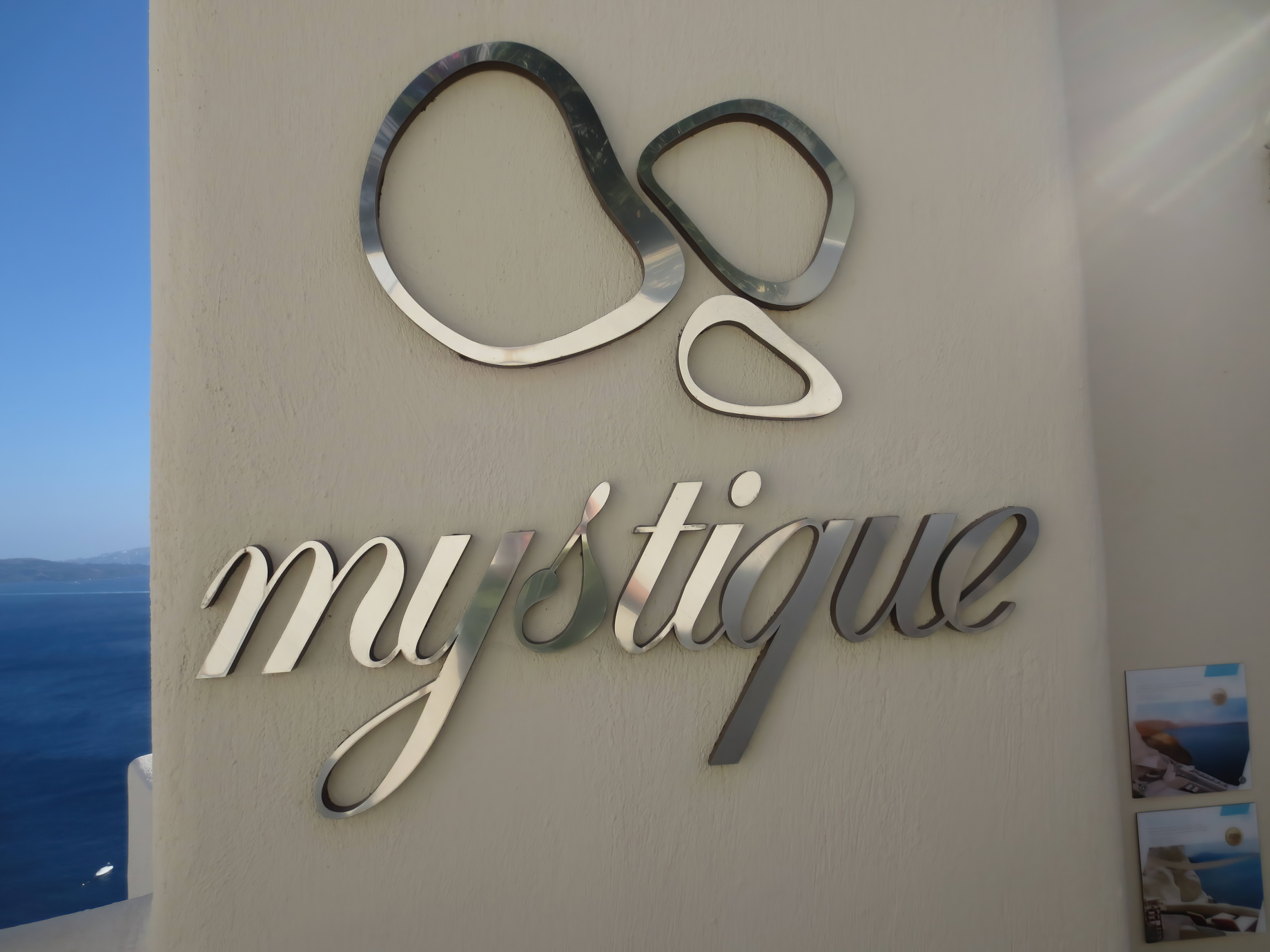 Mystique Hotel Santorini – Oia, Santorini Island, Greece – Mystique Wall Logo