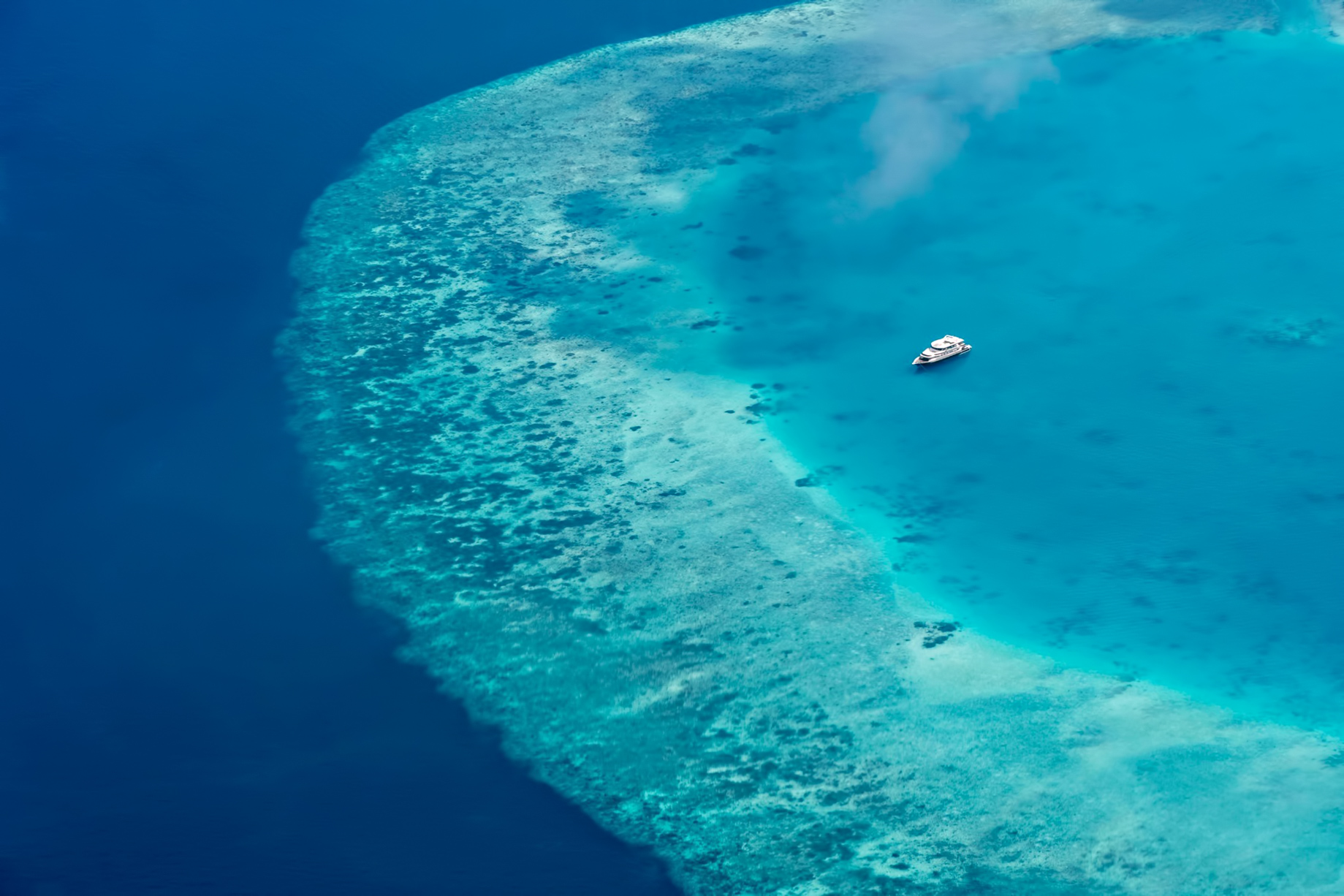 Cheval Blanc Randheli Resort – Noonu Atoll, Maldives – Boat on Indian Ocean Aerial