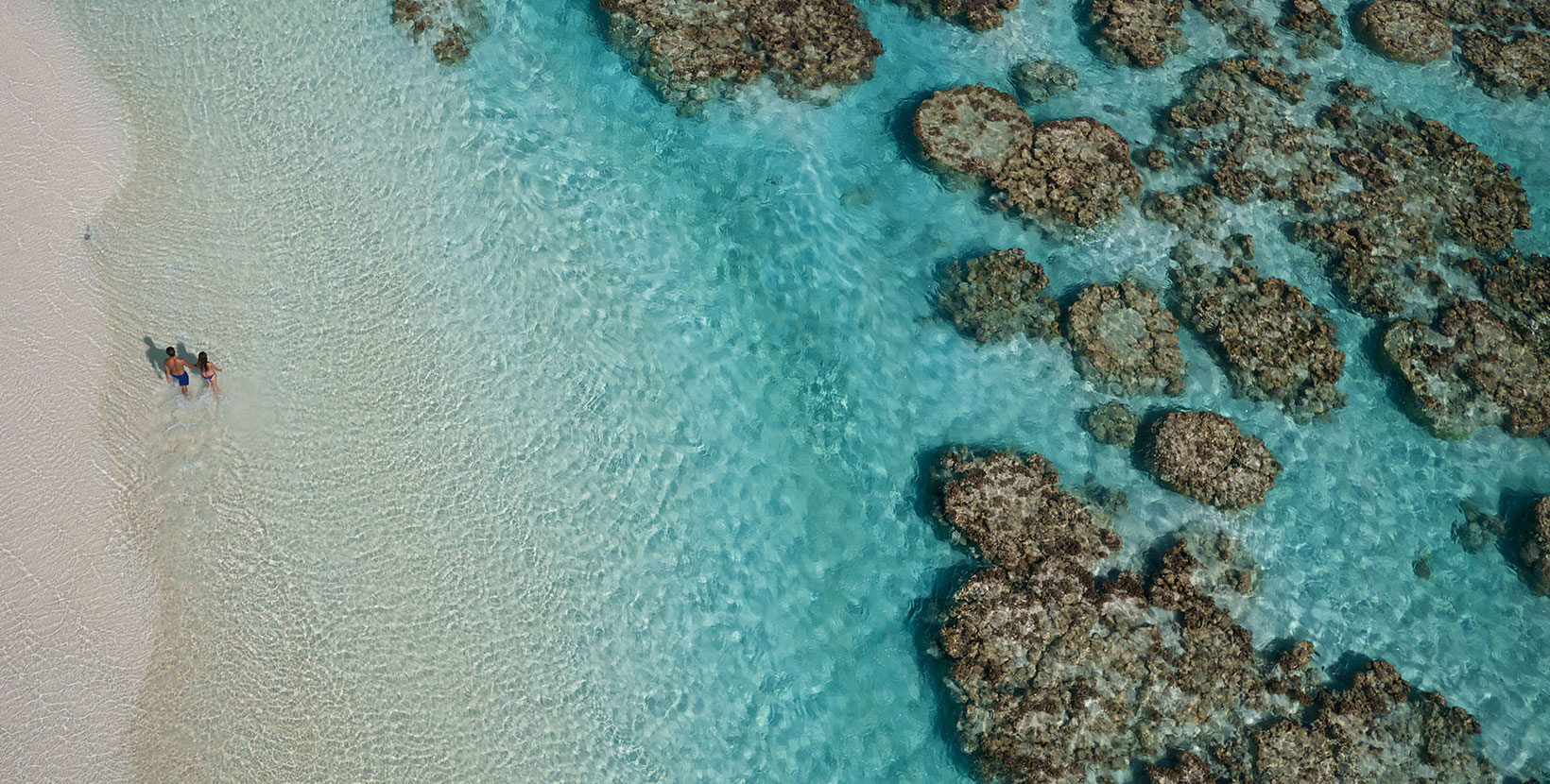 The Brando Resort - Tetiaroa Private Island, French Polynesia - Couple Walking on Beach