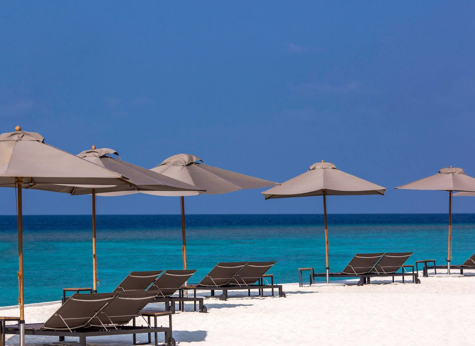 Amilla Fushi Resort and Residences – Baa Atoll, Maldives – Oceanfront Beach Chairs and Umbrellas