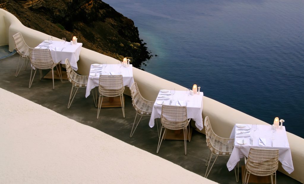 Mystique Hotel Santorini – Oia, Santorini Island, Greece - Cliffside Restaurant Tables Sea View