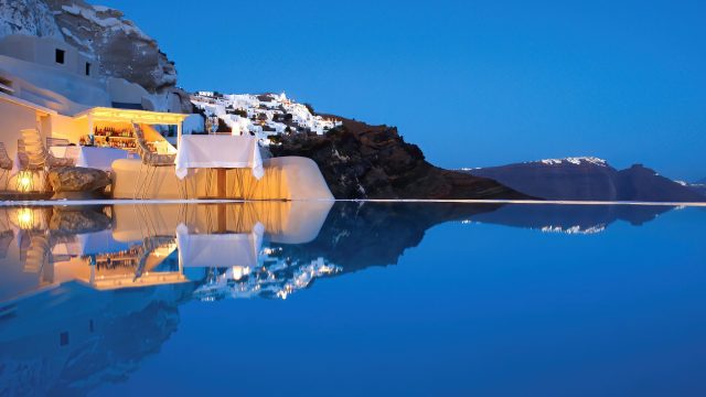 Mystique Hotel Santorini – Oia, Santorini Island, Greece - Cliffside Pool Deck Dining Tables