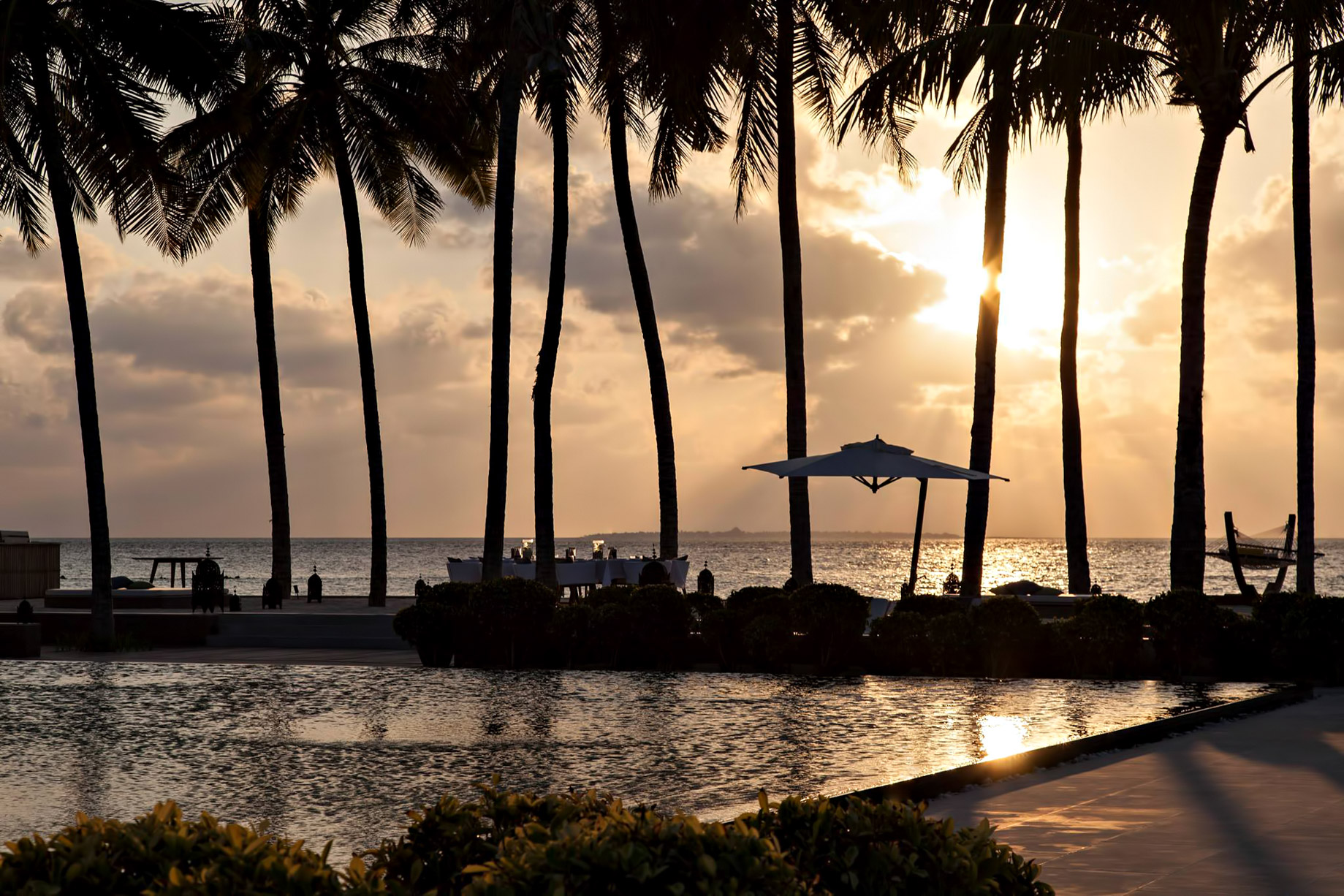 Cheval Blanc Randheli Resort – Noonu Atoll, Maldives – Beachfront Palm Trees Sunset