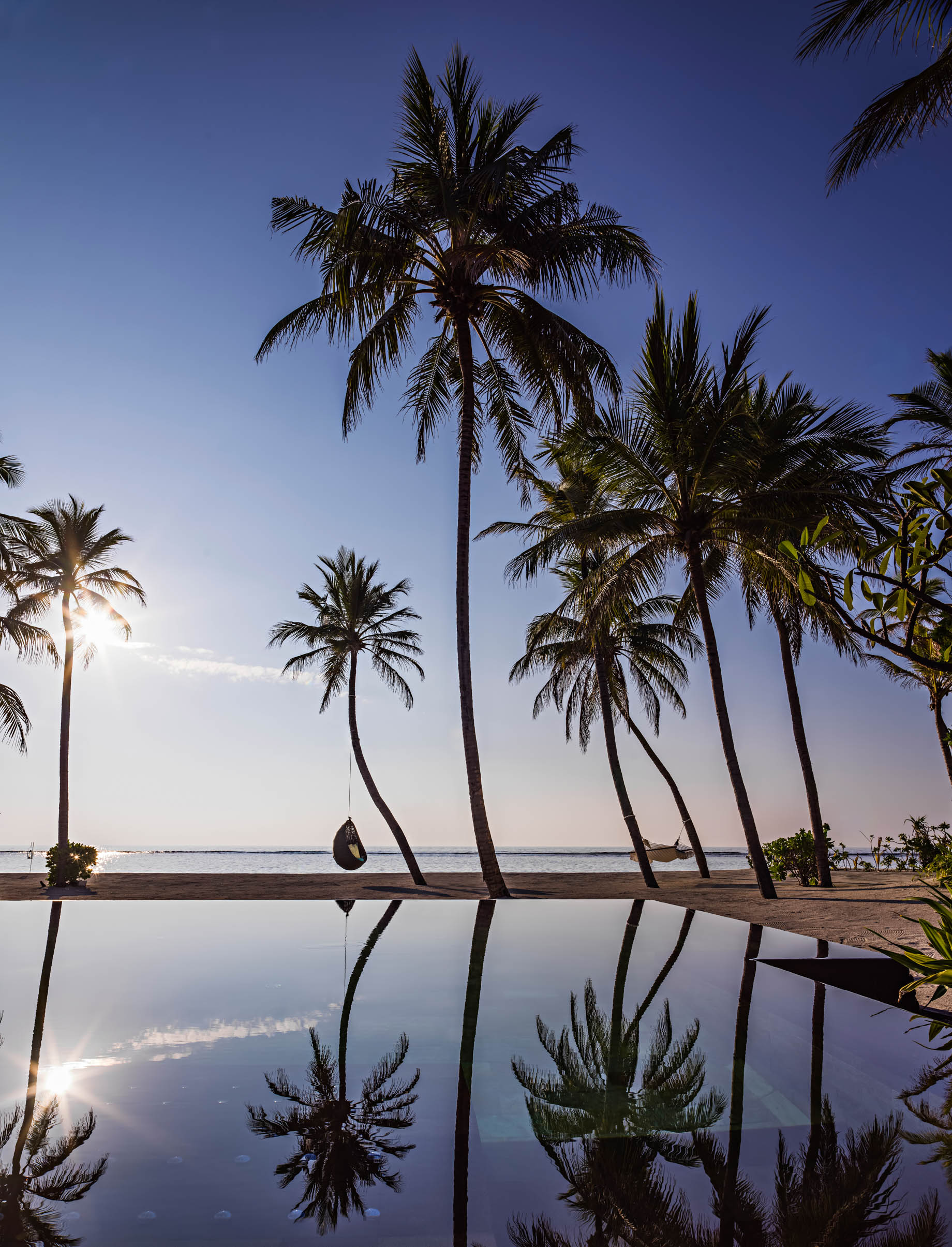 One&Only Reethi Rah Resort - North Male Atoll, Maldives - Palm Tree Chair Beach Pool View Twilight