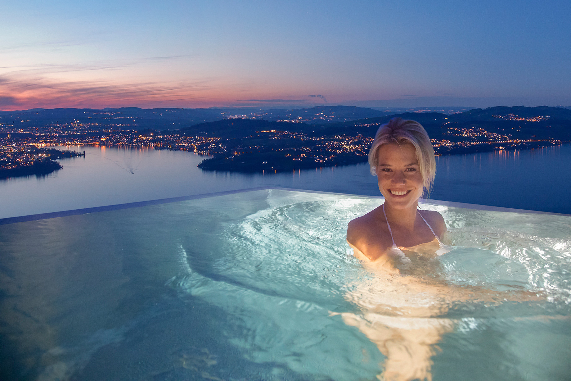 Burgenstock Hotel & Alpine Spa – Obburgen, Switzerland – Alpine Spa Outdoor Infinity Edge Pool Sunset Lake View