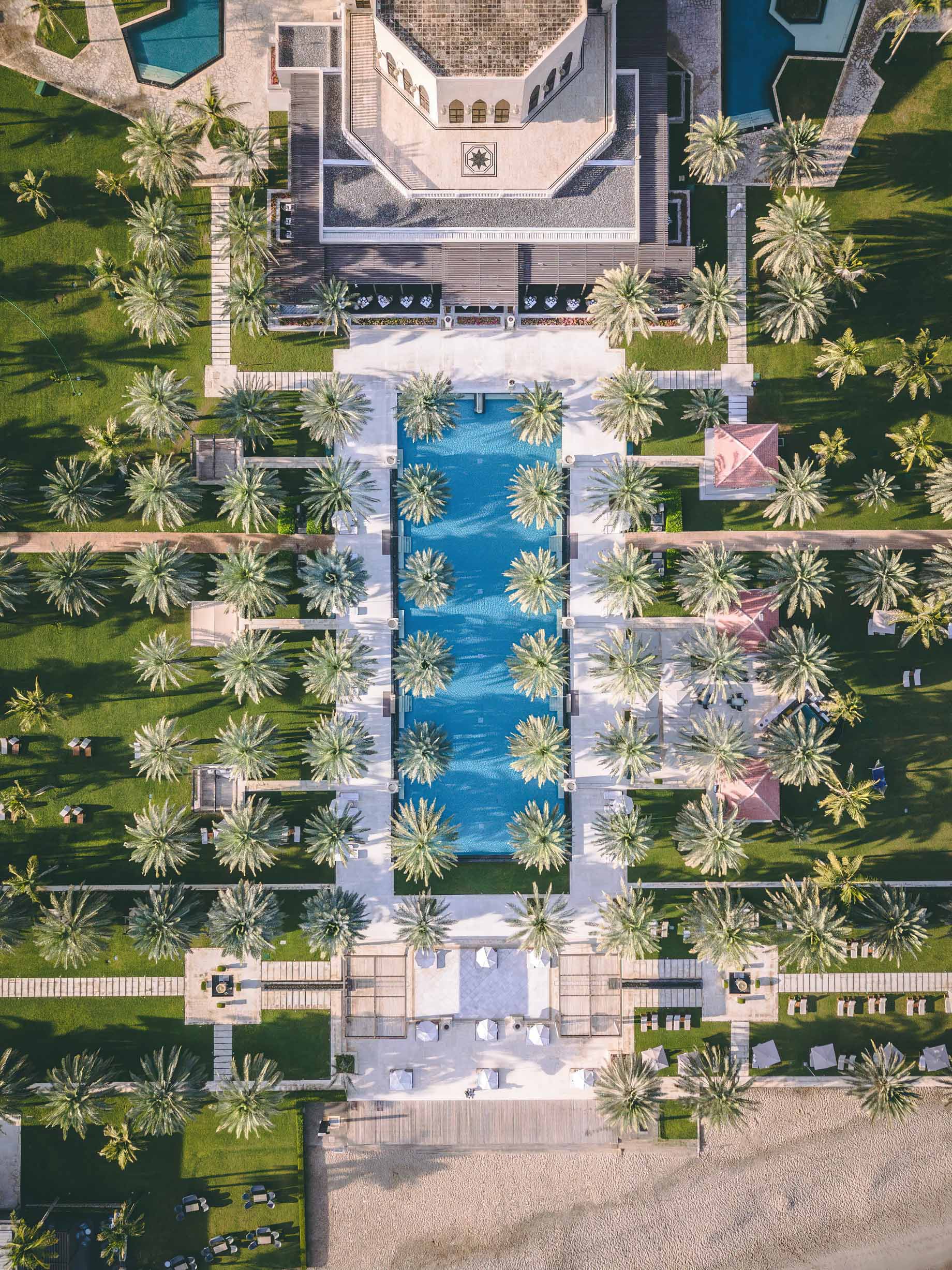 Al Bustan Palace, A Ritz-Carlton Hotel – Muscat, Oman – Infinity Pool Overhead Aerial View