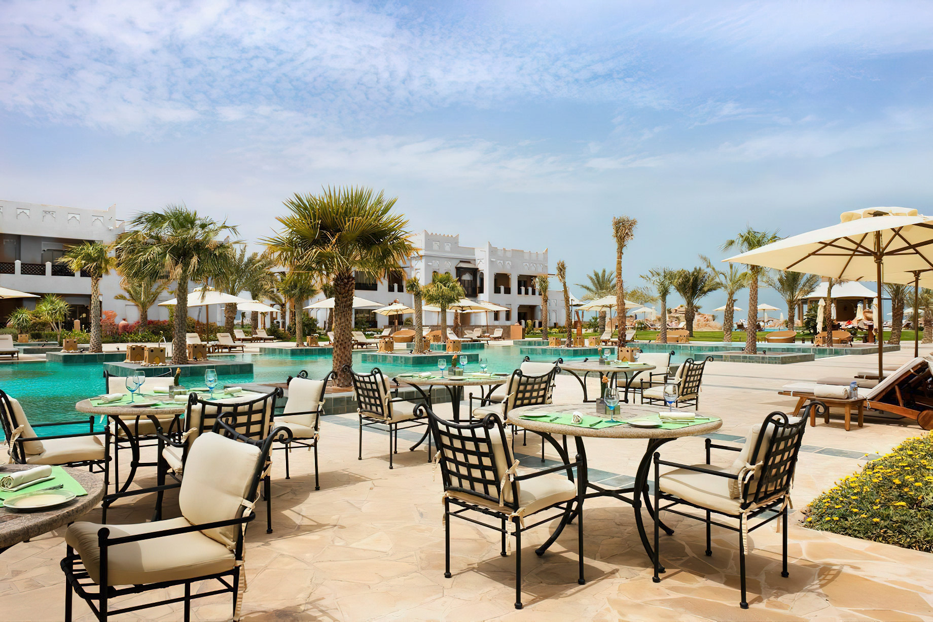 Sharq Village & Spa, A Ritz-Carlton Hotel – Doha, Qatar – Outdoor Pool Deck Dining Tables