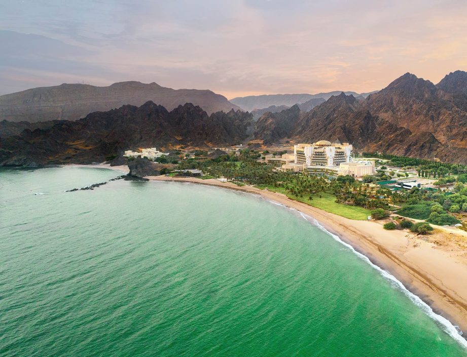 Al Bustan Palace, A Ritz-Carlton Hotel - Muscat, Oman - Hotel Aerial View Sunset