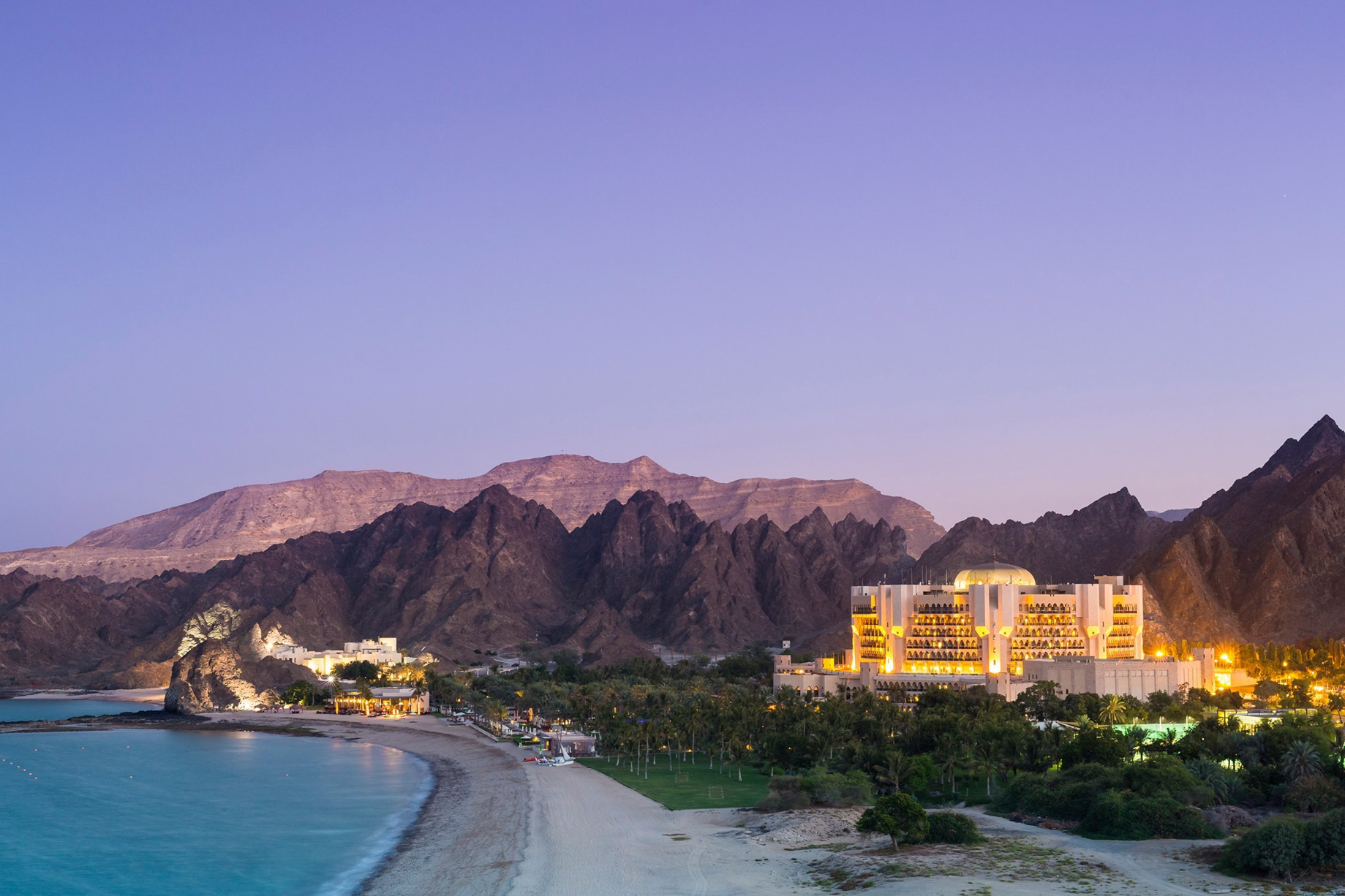 Al Bustan Palace, A Ritz-Carlton Hotel – Muscat, Oman – Hotel Aerial View Evening