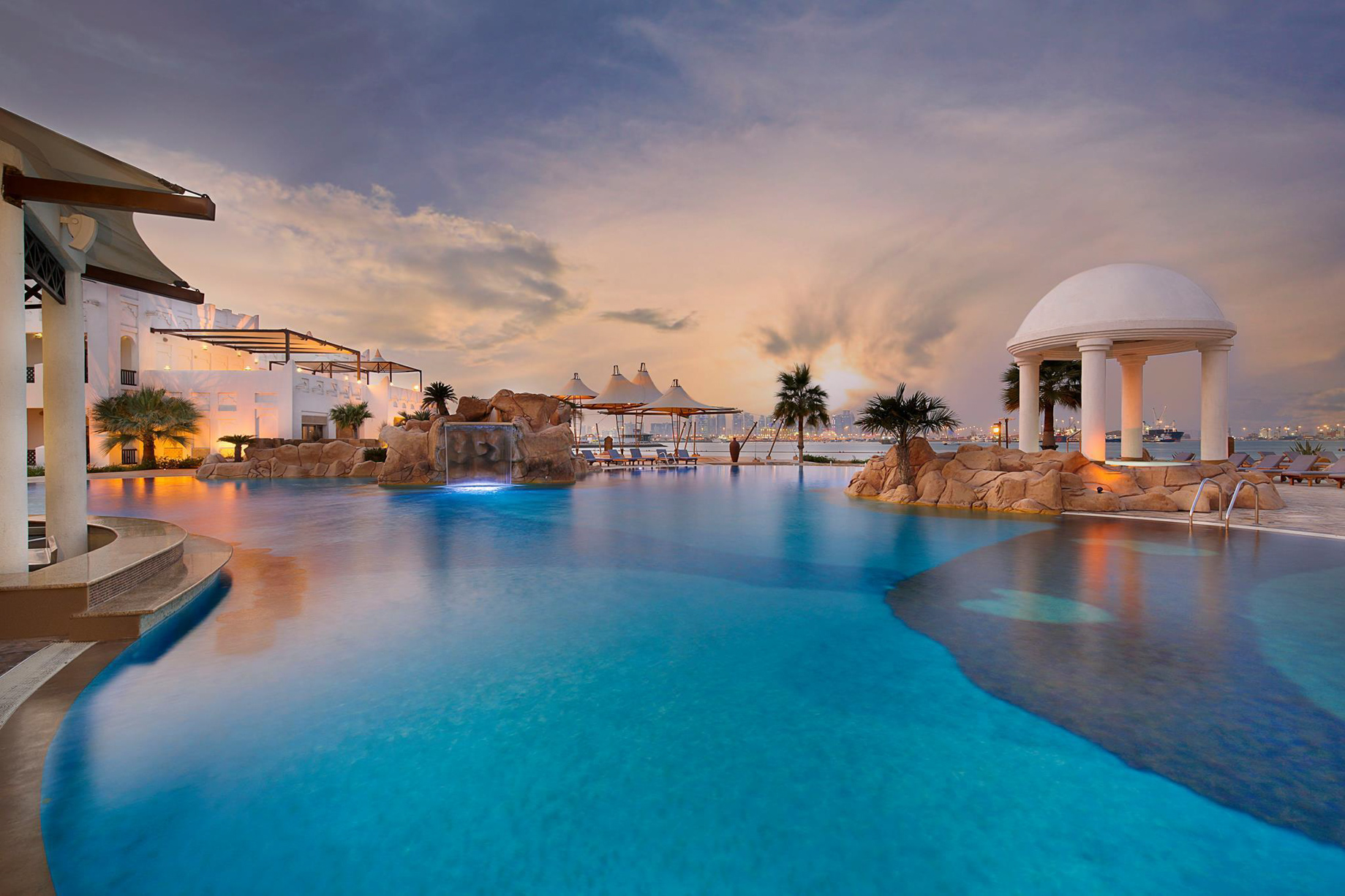 Sharq Village & Spa, A Ritz-Carlton Hotel – Doha, Qatar – Exterior Pool Sunset City View