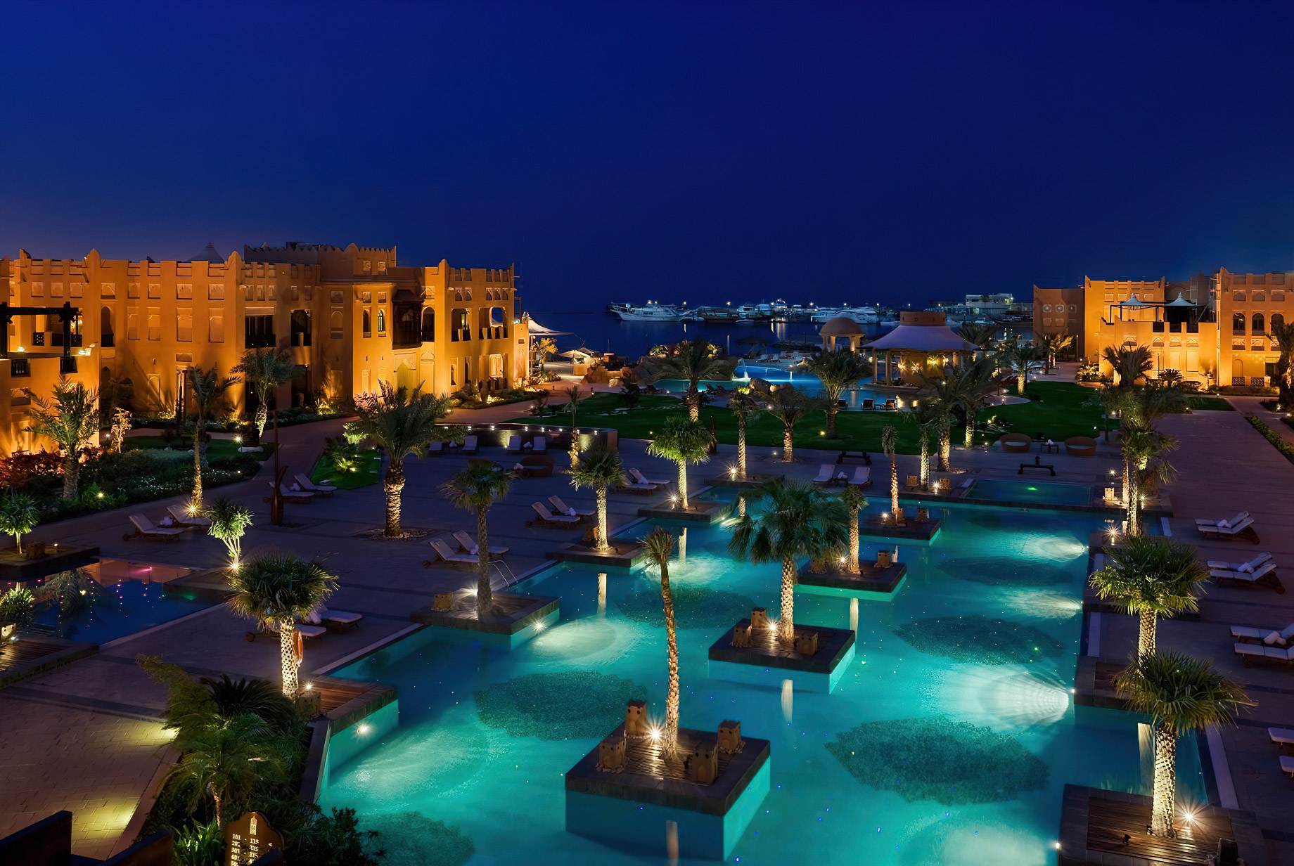 Sharq Village & Spa, A Ritz-Carlton Hotel – Doha, Qatar – Pool Night Aerial Ocean View