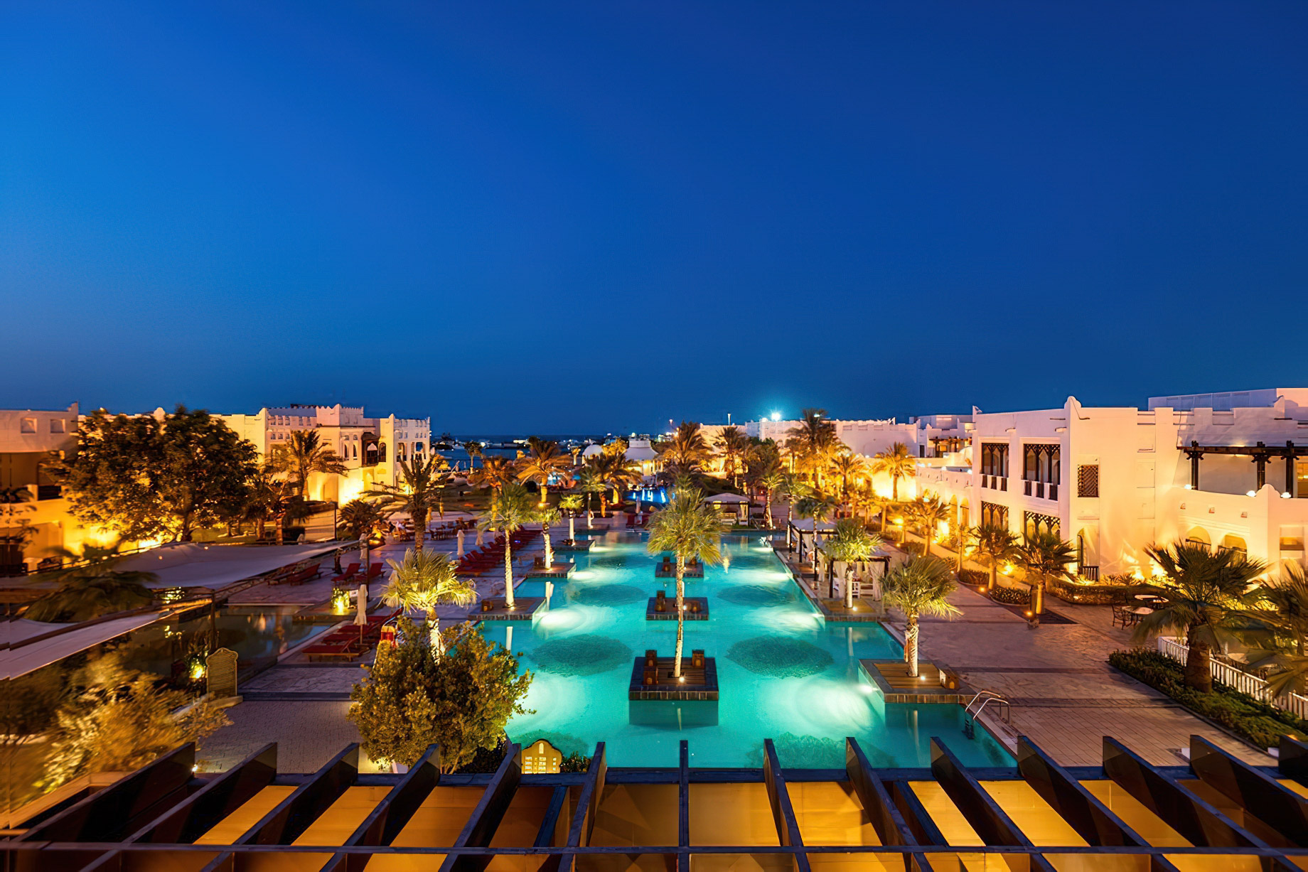 Sharq Village & Spa, A Ritz-Carlton Hotel - Doha, Qatar - Pool Deck Night Aerial View
