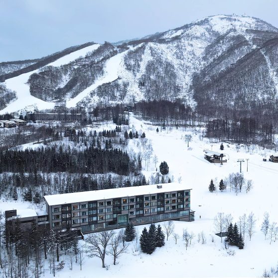 Higashiyama Niseko Village, A Ritz-Carlton Reserve Hotel - Hokkaido, Japan - Winter Exterior Aerial Mountain View