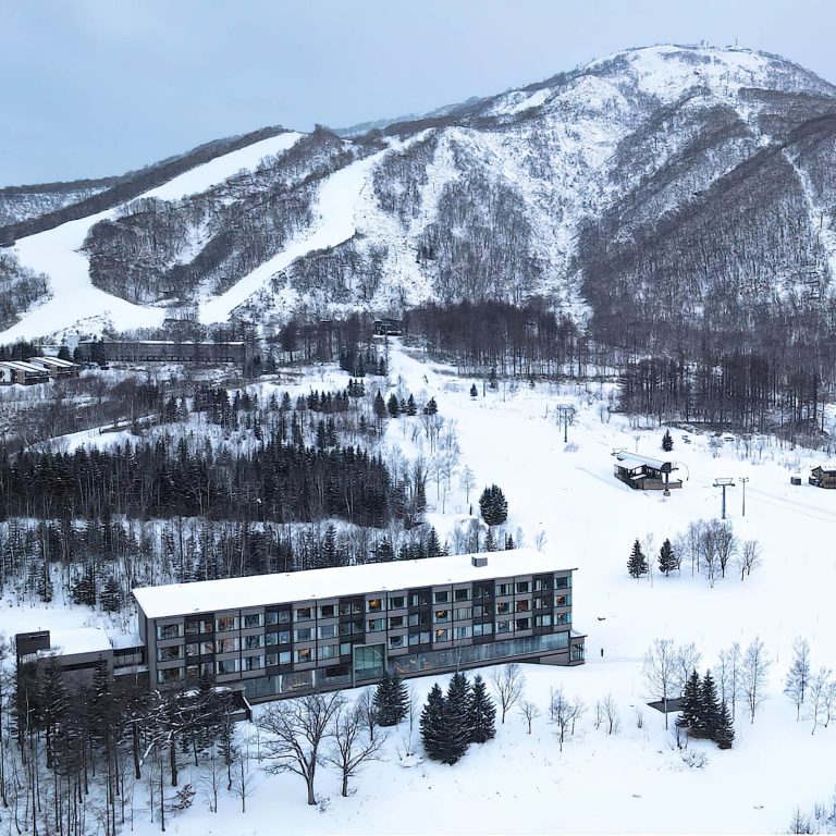 Higashiyama Niseko Village, A Ritz-Carlton Reserve Hotel – Hokkaido, Japan – Winter Exterior Aerial Mountain View