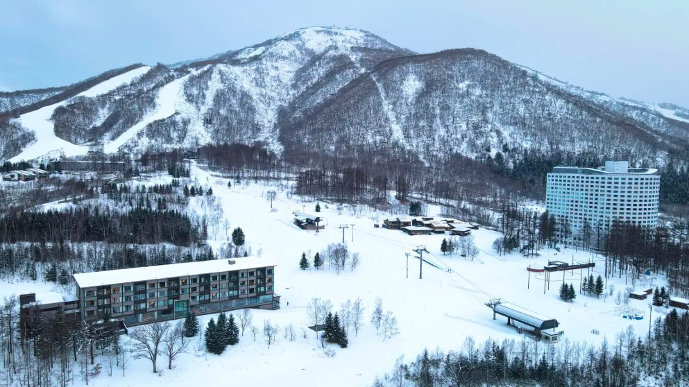 Higashiyama Niseko Village, A Ritz-Carlton Reserve Hotel - Hokkaido, Japan - Winter Exterior Aerial Mountain View