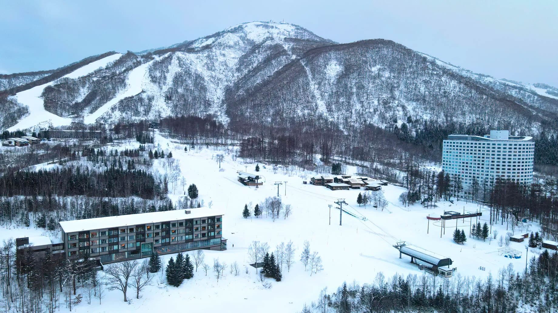 Higashiyama Niseko Village, A Ritz-Carlton Reserve Hotel – Hokkaido, Japan – Winter Exterior Aerial Mountain View