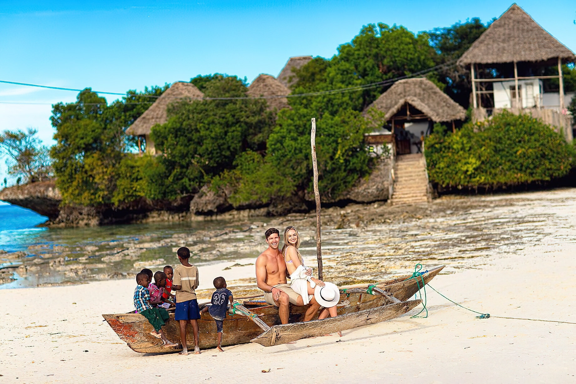 The Island Pongwe Lodge – Pongwe, Zanzibar, Tanzania – Couple Sitting on Boat at Low Tide