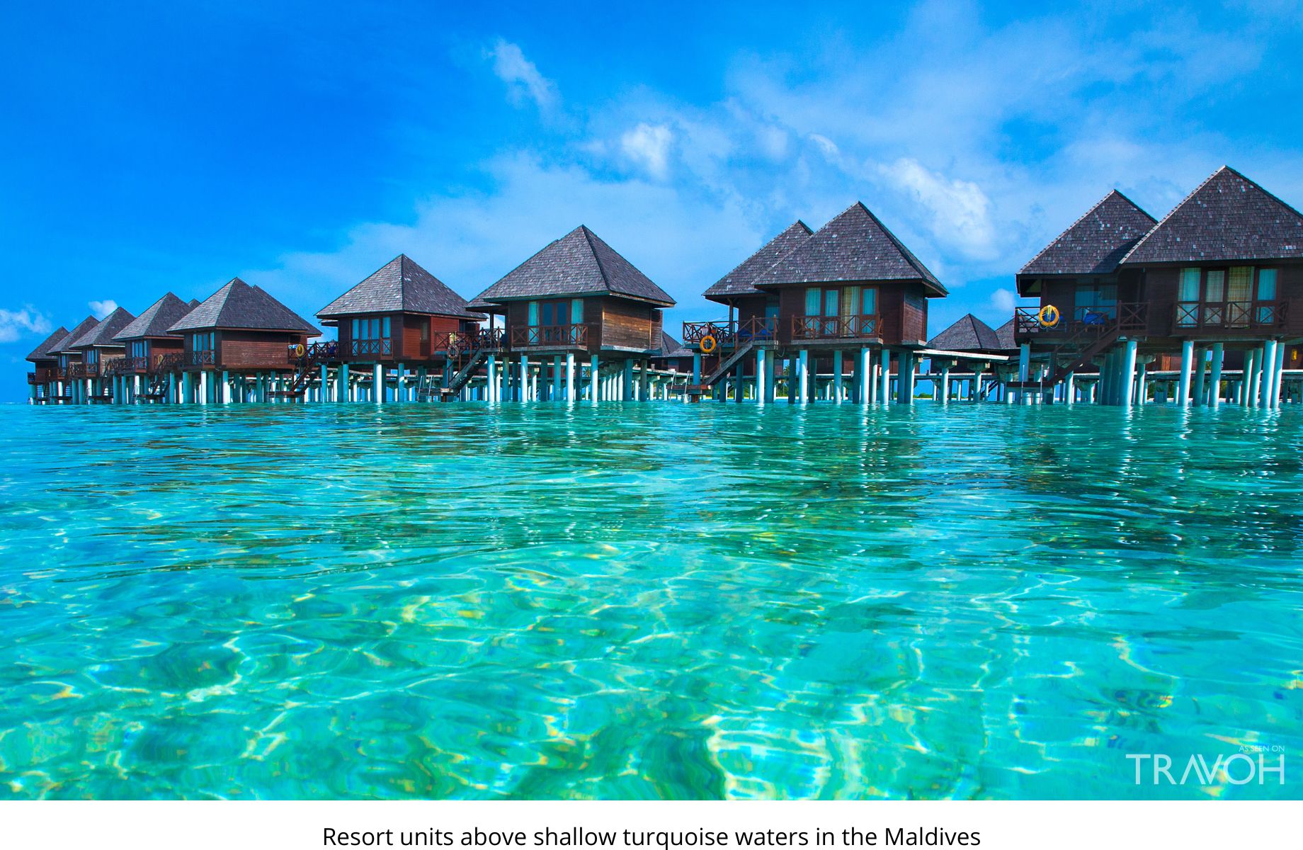 Resort units above shallow turquoise waters in the Maldives – TRAVOH