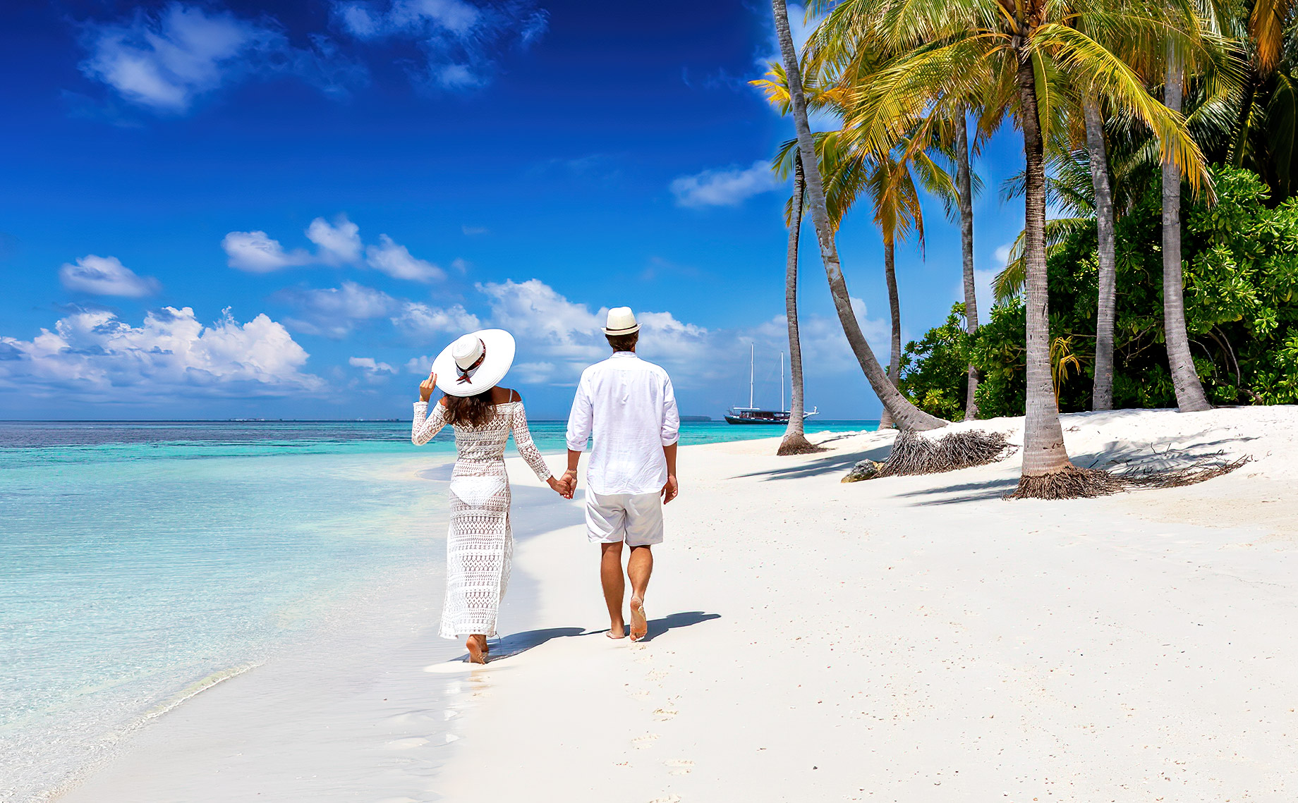 Elegant Couple Walking On A Tropical Beach In The Maldives