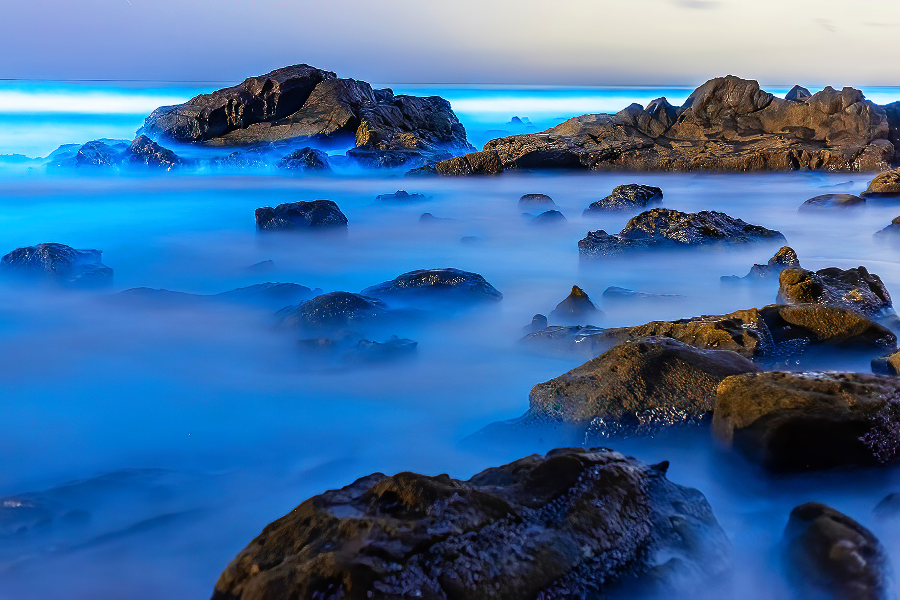 Rocky Shoreline Glowing With Bioluminescence At Scripps Beach, La Jolla, California, USA