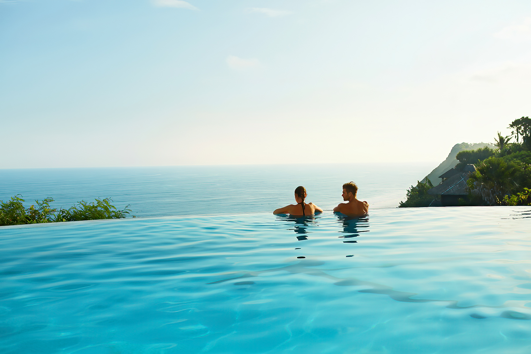 Vacation Couple Relaxing In Infinity Pool