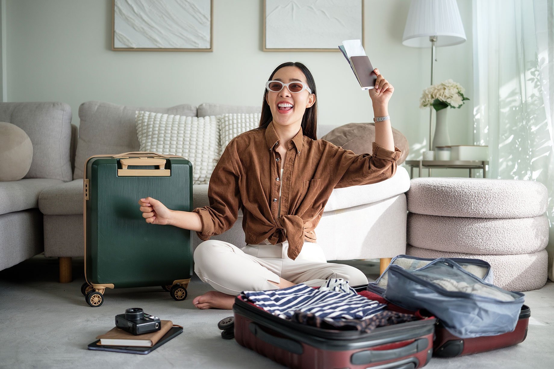 Woman Holding Passport and Ticket with Travel Luggage Packed