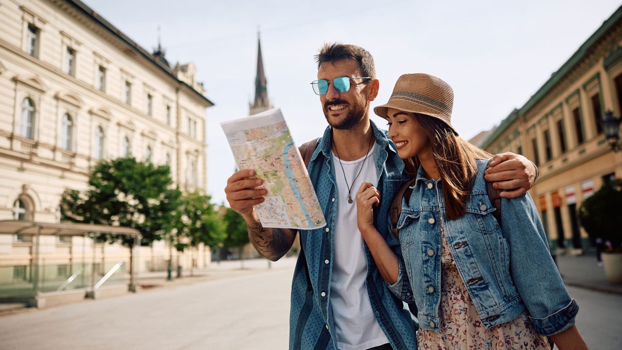 Couple Walking Through a European City with a Map