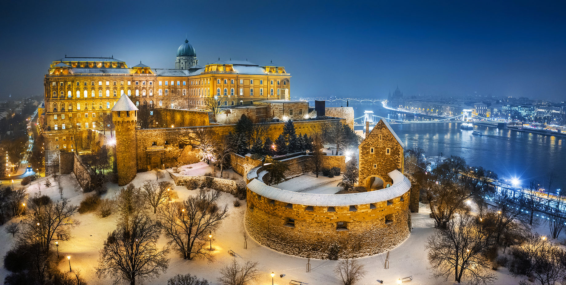 Aerial View of Illuminated Buda Castle Royal Palace on a Snowy Winter Night in Budapest, Hungary