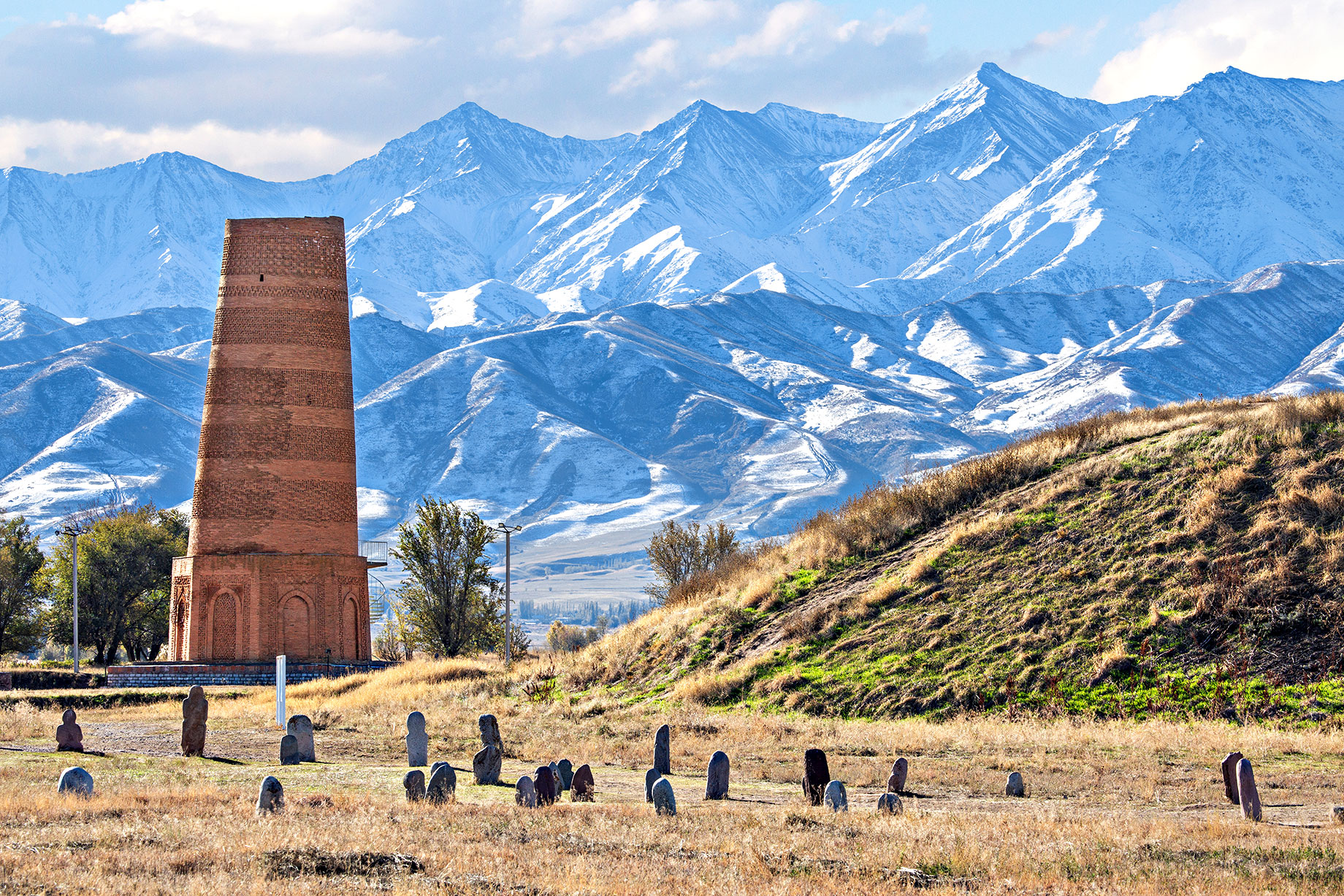 Burana Tower - An Old Minaret in the Ruins of the Ancient Site of Balasagun in Kyrgyzstan with Tombstones Known as Balbas