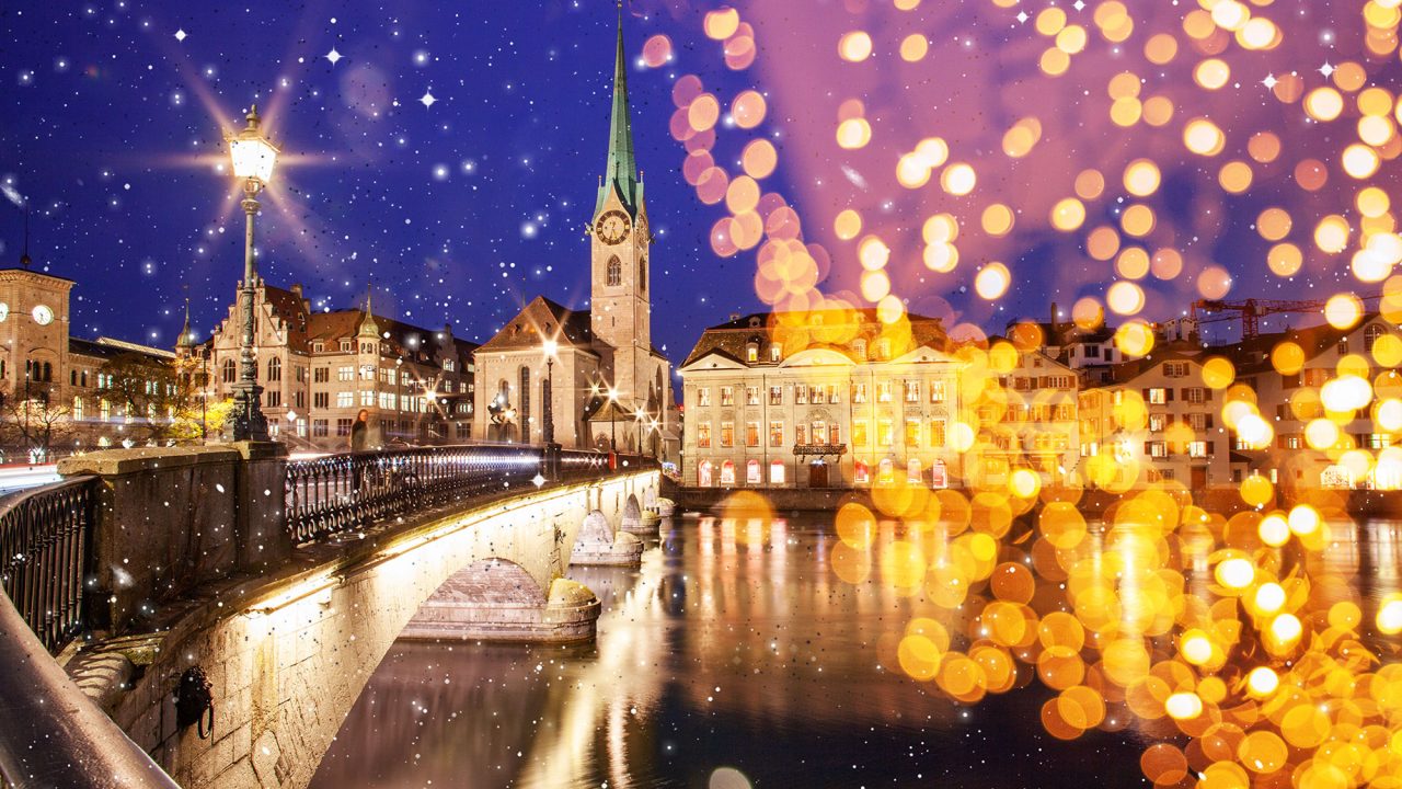 Christmas Lights Over View of Fraumunster and Grossmunster Churches and River Limmat in Zurich, Switzerland