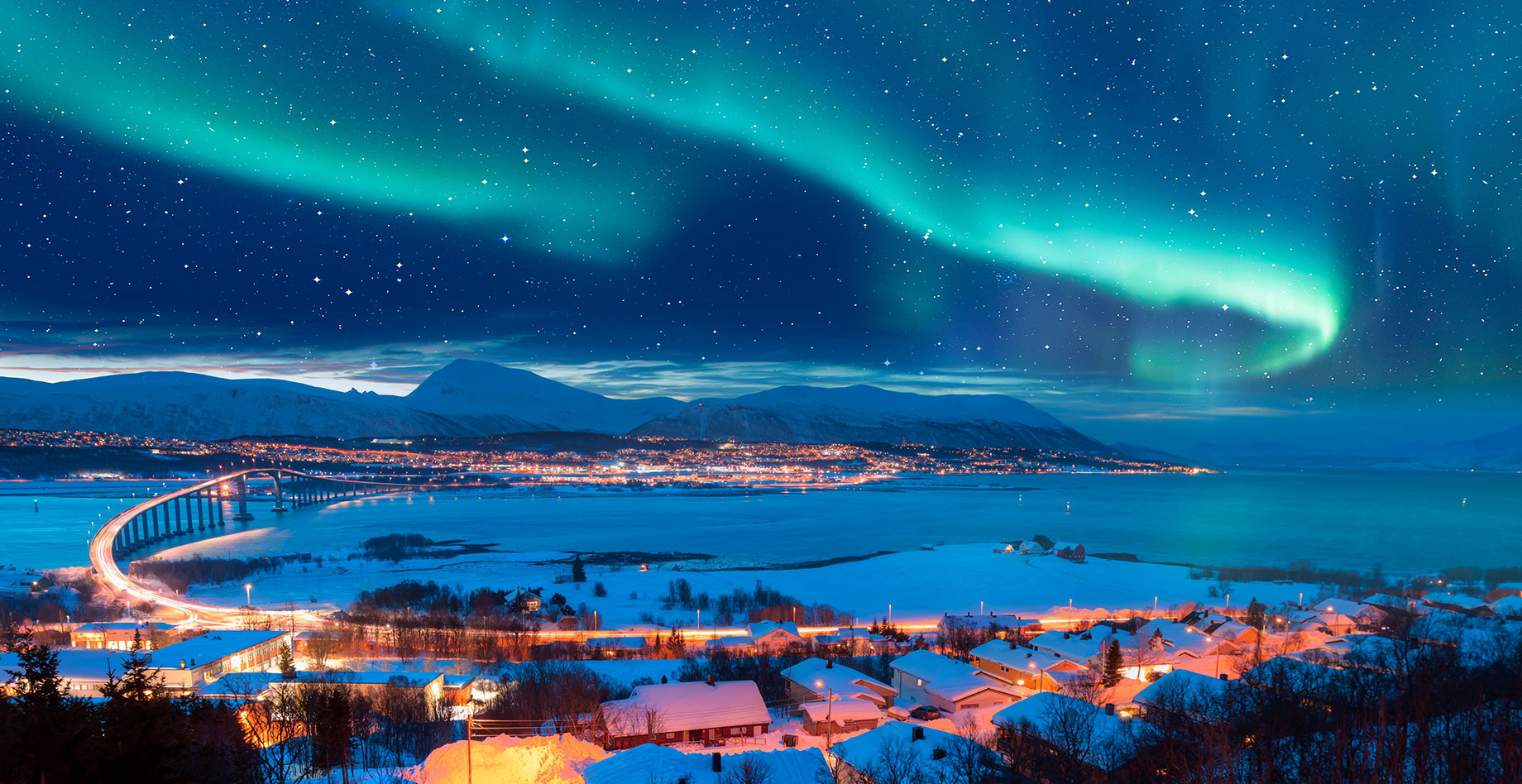 Spectacular Aurora Borealis in the Sky Over Tromsø, Norway with a View of the Sandnessundet Bridge