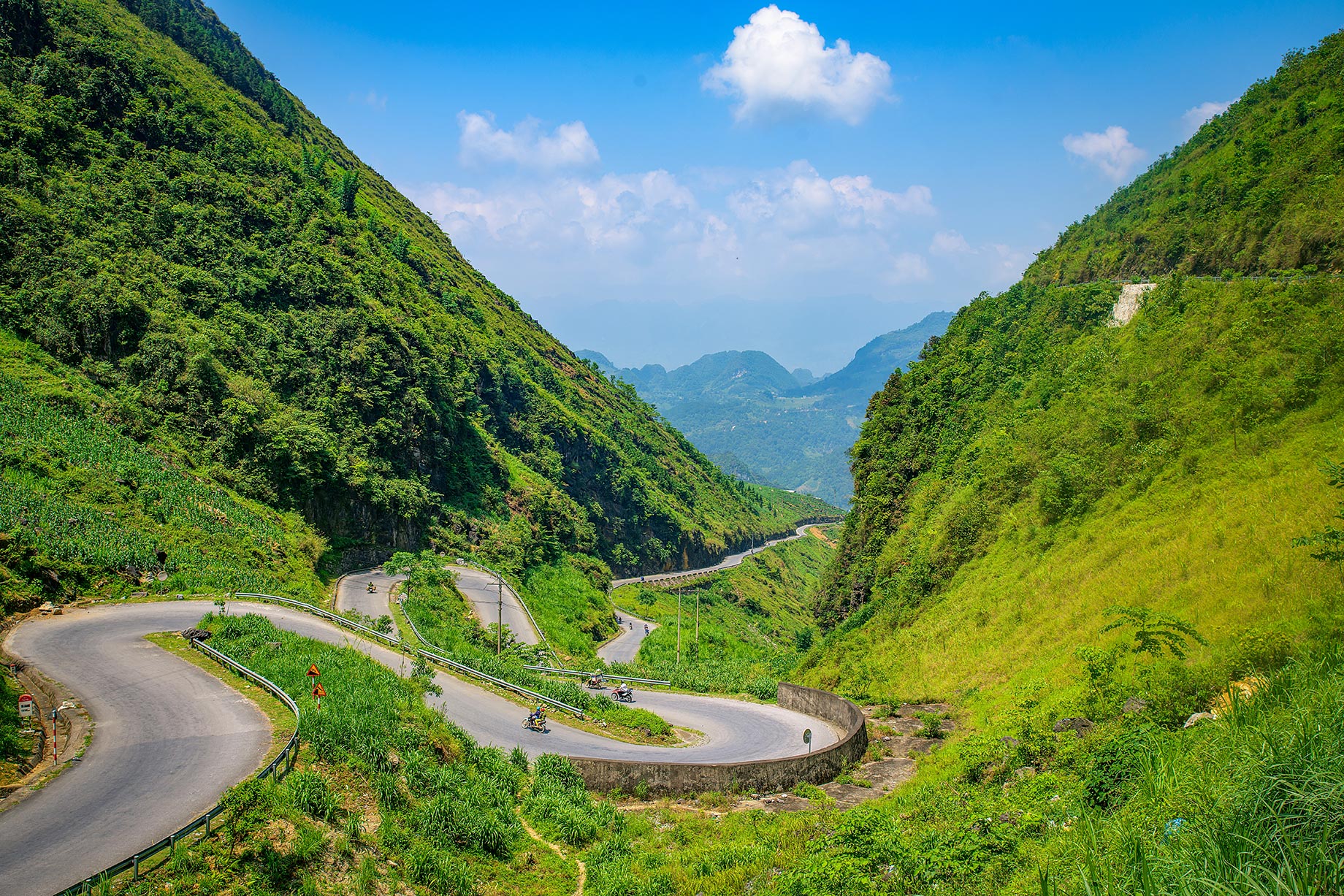 Twisting Mountain Roads Cutting Through Lush Green Valleys of the Hà Giang Loop in Northern Vietnam