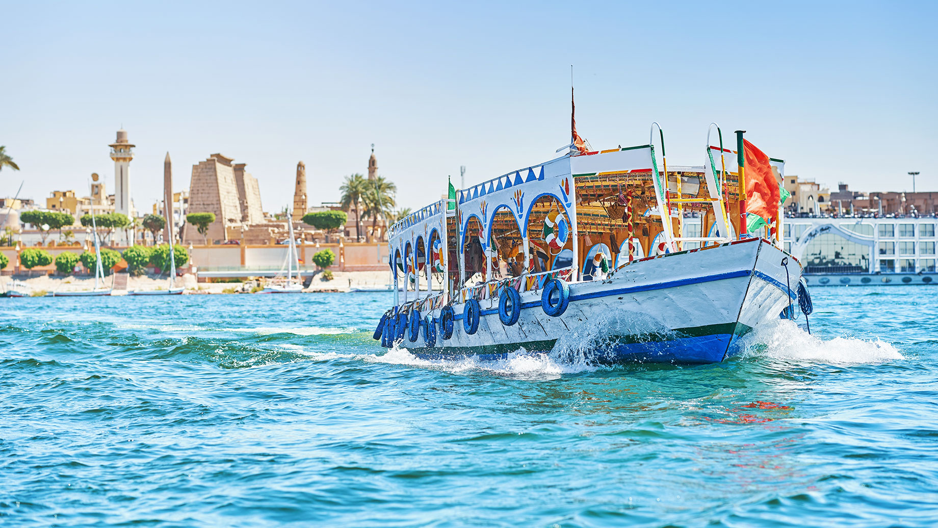 Boat of Tourists Cruising on the Nile River in Luxor, Egypt