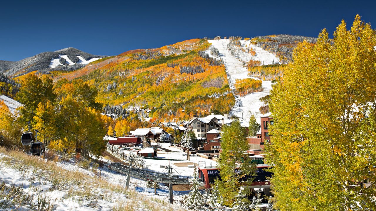 Snow on Golden Aspen Trees at Beaver Creek Resort in Colorado with Ski Slopes and Gondola