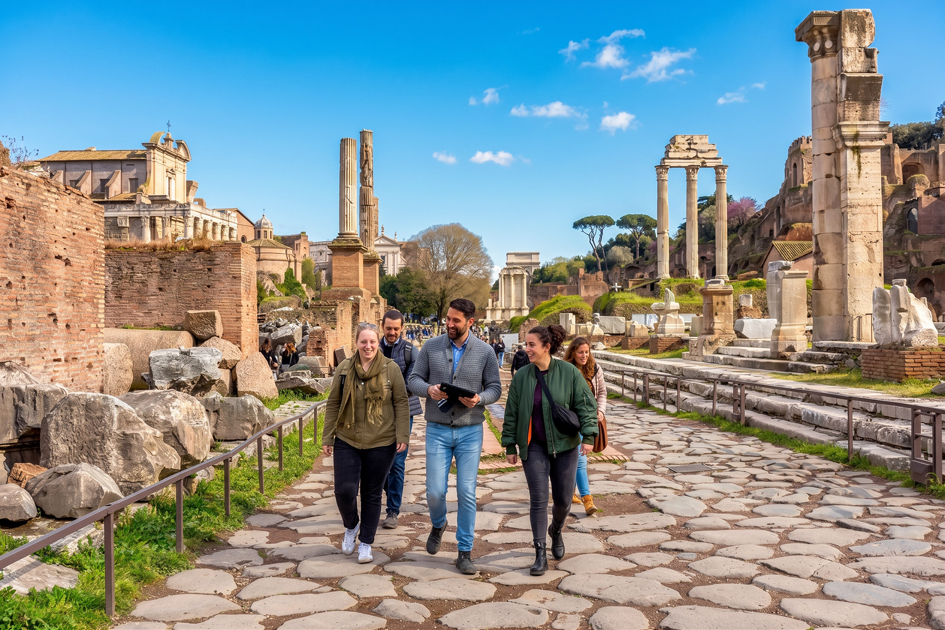 Private tour group walking along a stone path through ancient Roman ruins.