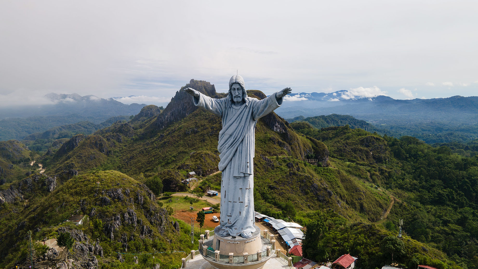 A Roman Catholic Monument of Jesus Blessing in the Mountainous Landscape of Toraja, Indonesia
